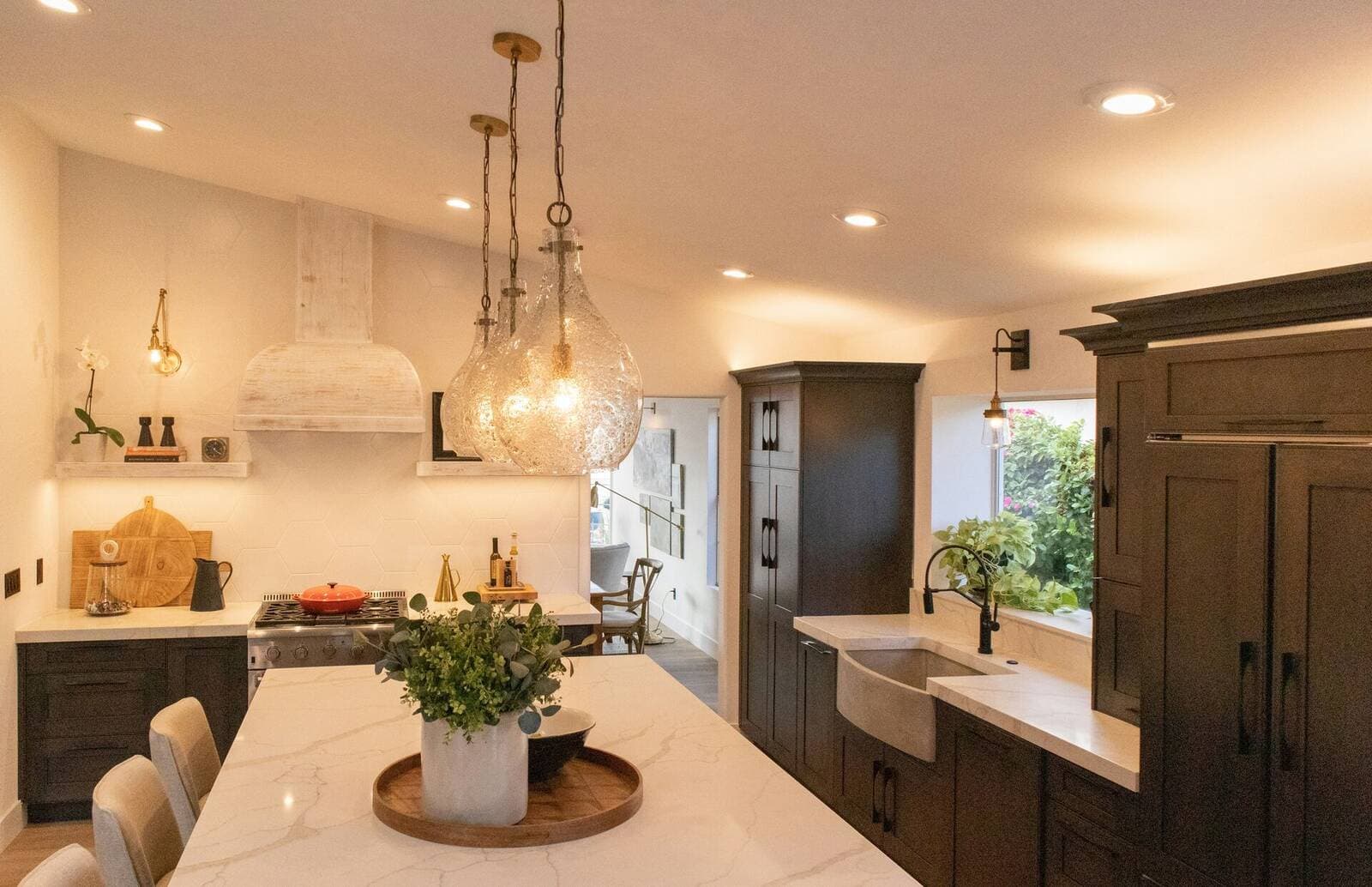 Modern kitchen island with white countertop and dark cabinetry in a recently remodeled Vancouver, WA home