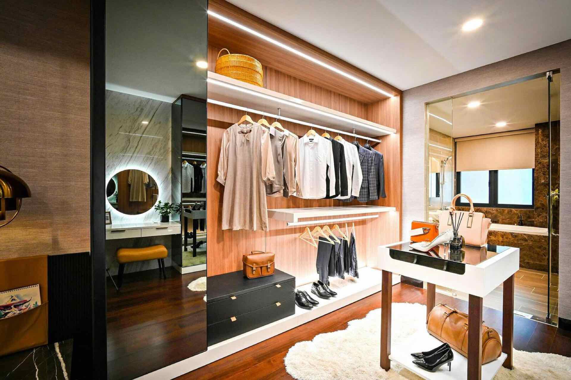 Custom walk-in closet with built-in shelving, drawers, and hanging rods in a Vancouver, WA primary bedroom suite